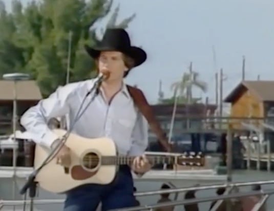 George Strait performs his debut single "Unwound" on a boat.