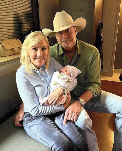 Photo of Alan Jackson and his wife Denise with their grandson, Jackson