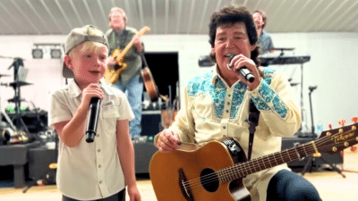 Marty Raybon of Shenandoah sings with five-year-old Cutler Lumbard