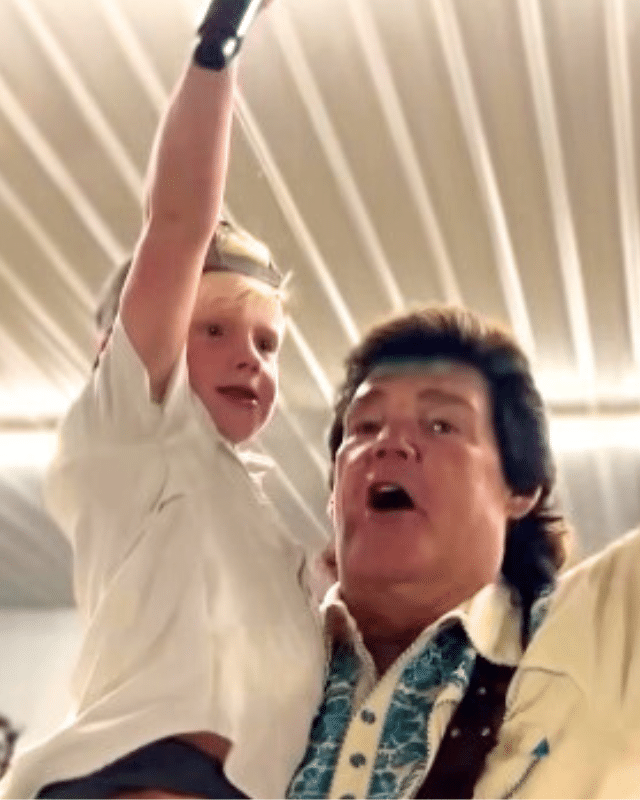 Marty Raybon of Shenandoah sings with five-year-old Cutler Lumbard