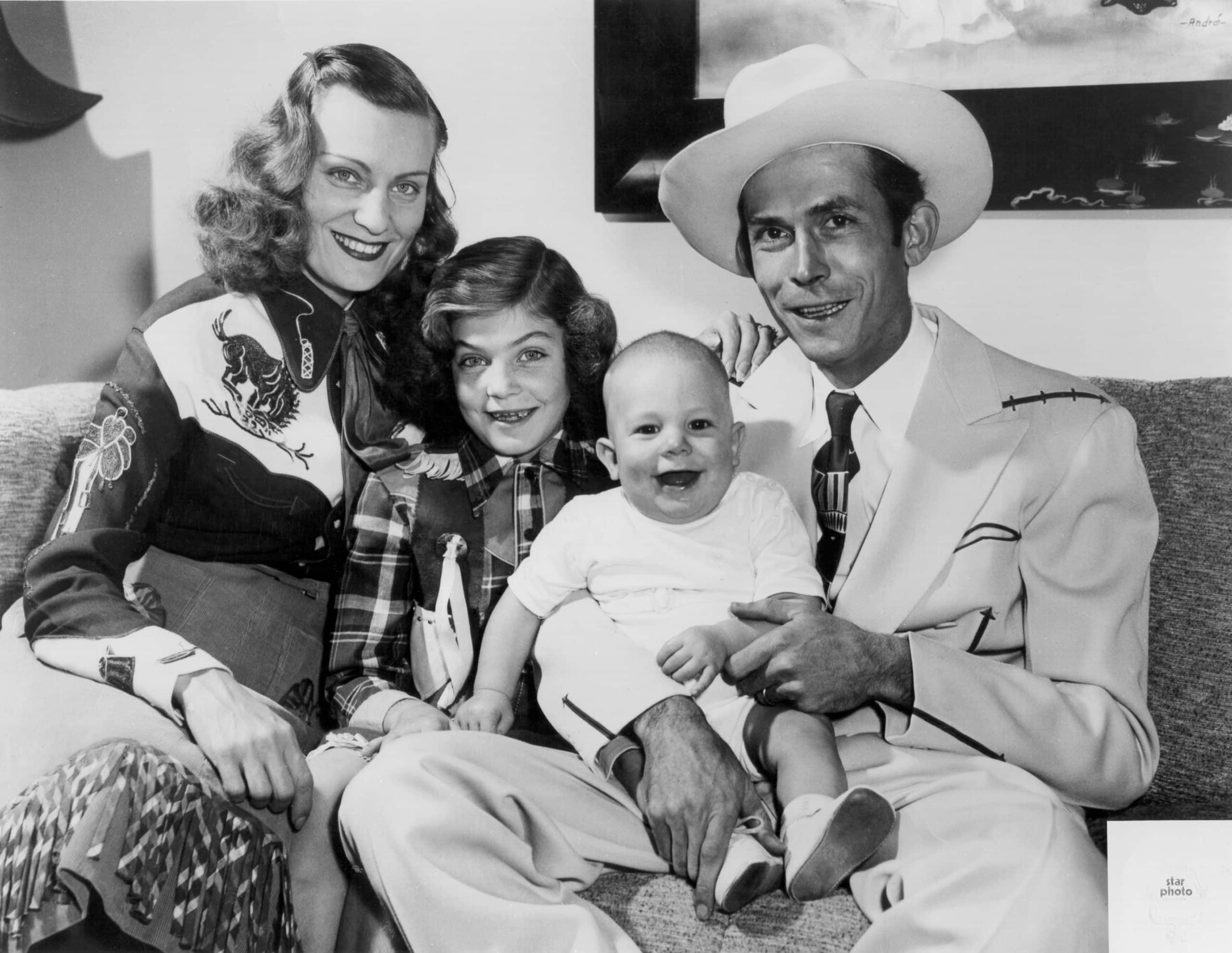 NASHVILLE - 1949: The Williams family Left to Right Audrey Williams, Lycretia Williams, Hank Williams Jr and Hank Williams Sr pose for a portrait in 1949 in Nashville Tennessee.