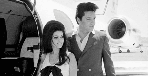 Elvis and Priscilla Presley next to their plane