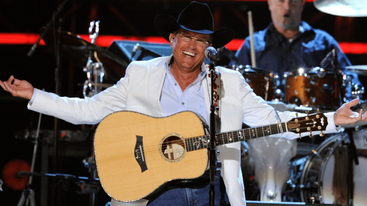 George Strait performs with guitar on stage
