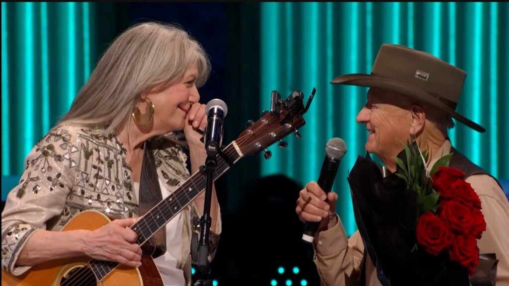 Charlie McCoy invites Kathy Mattea to become the next member of the Grand Ole Opry.