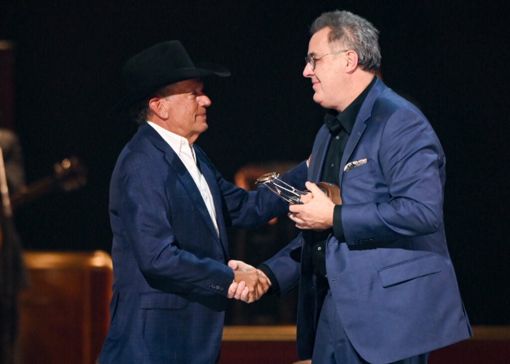 George Strait gives Vince Gill the trophy for the Willie Nelson Lifetime Achievement Award
